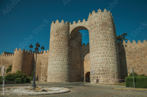 San Vicente Gate with two towers in front of street at Avila