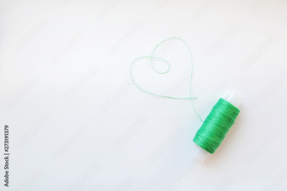 Multicolored thread coils on pink blue background. Sewing supplies and accessories for needlework, stitching, embroidery. space for text. flat lay, top view Multicolored thread coils on pink blue background. Sewing supplies and accessories for needlework, stitching, embroidery. space for text. flat lay, top view