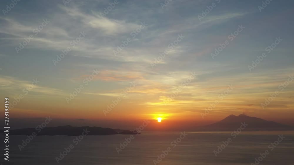 The sun sets over the tropical Pacific Ocean silhouetting islands near Komodo National Park, Indonesia. This region is popular due to its dragons as well as its amazing marine biodiversity. The sun sets over the tropical Pacific Ocean silhouetting islands near Komodo National Park, Indonesia. This region is popular due to its dragons as well as its amazing marine biodiversity.