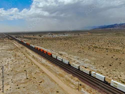 Cargo locomotive railroad engine crossing Arizona desert wilderness. Freight train passing by the desert. USA photo