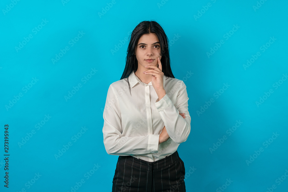 Attractive young girl close-up with big eyes. Business woman look at camera with serious face Attractive young girl close-up with big eyes. Business woman look at camera with serious face