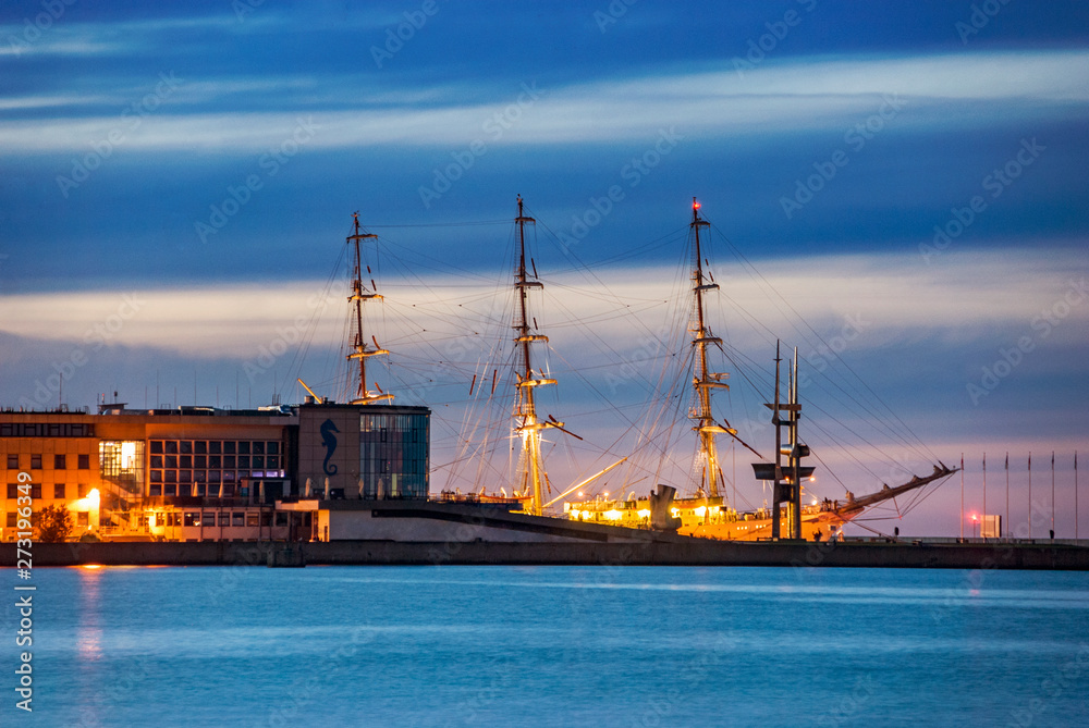 Harbor pier with ship and buildings