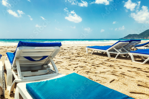 Beach chairs on a sandy beach by the sea. photo