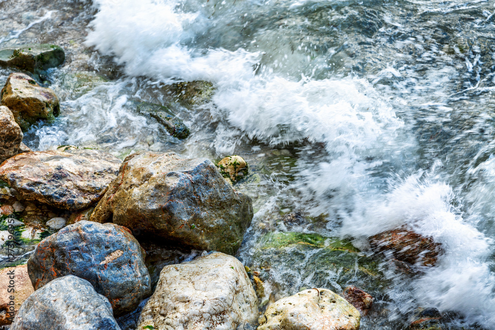 Sea waves are beating on the stones, close-up. Space for text. Background. Sea waves are beating on the stones, close-up. Space for text. Background.