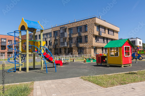 New three-storey residential building. Playground in the yard. New residential area
