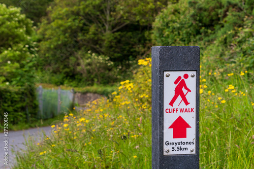 Vászonkép Red sign showing the beginning of the scenic Cliff Walk path from Bray to Greystones, Co
