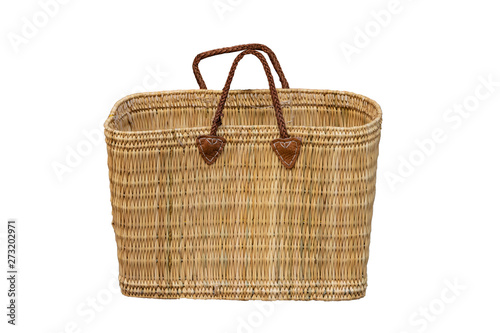 Empty basket isolated. Closeup of fashionable decorative empty basket weave bag with brown leather handles isolated on a white background. Wicker basket fashion.