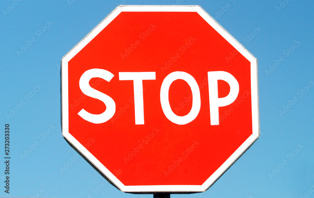 Sign STOP on blue sky background.