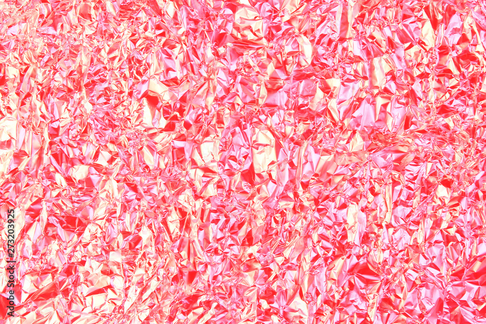 Texture of crumpled foil with red toned