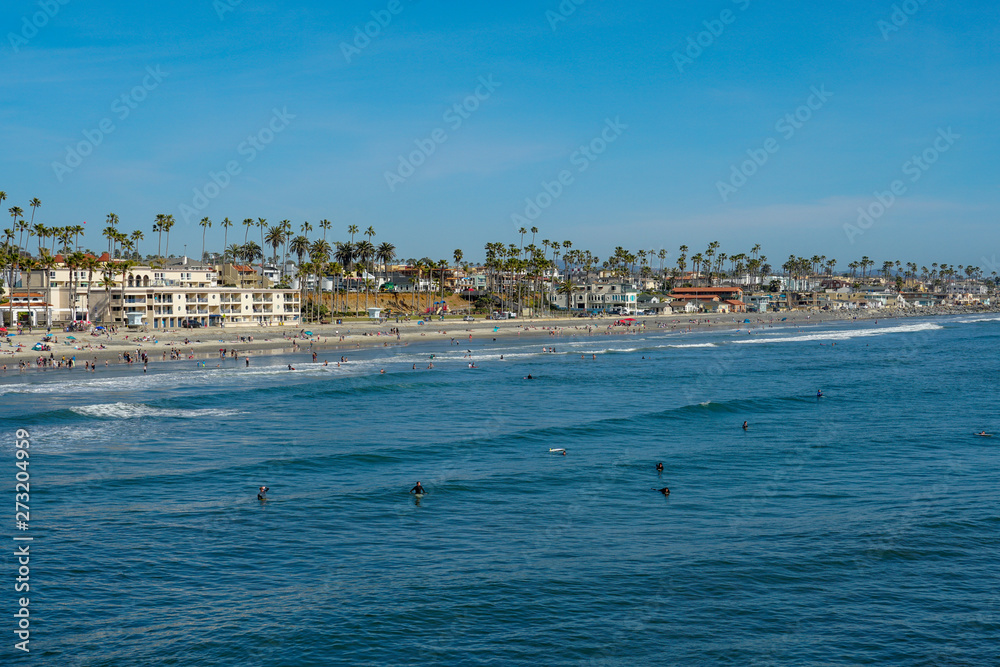 People on the beach enjoying beautiful spring day at Oceanside beach in San Diego, California. 