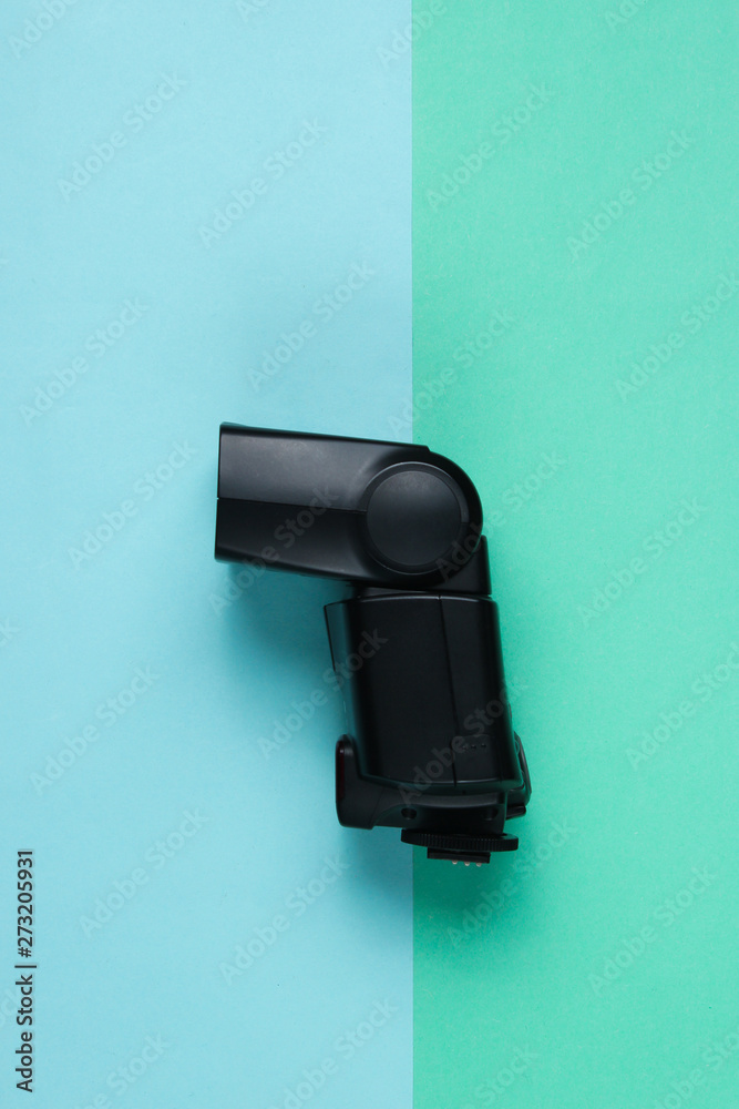 Camera flash on colored paper background. Top view