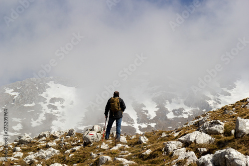 hiker on mountain peak in matese park and fog