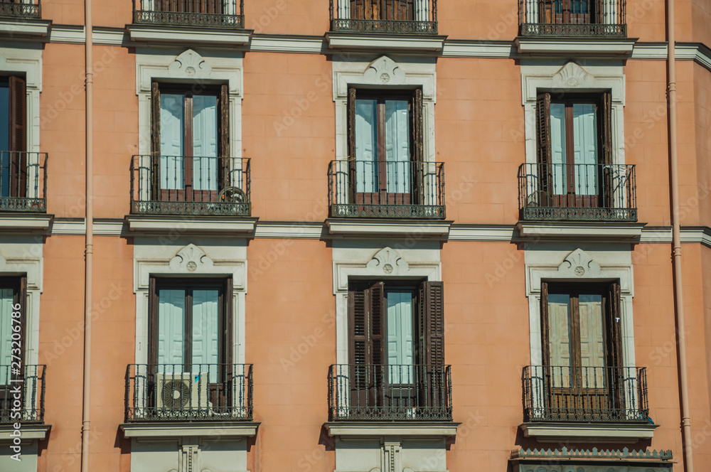 Building with colorful facade and glazed windows in Madrid