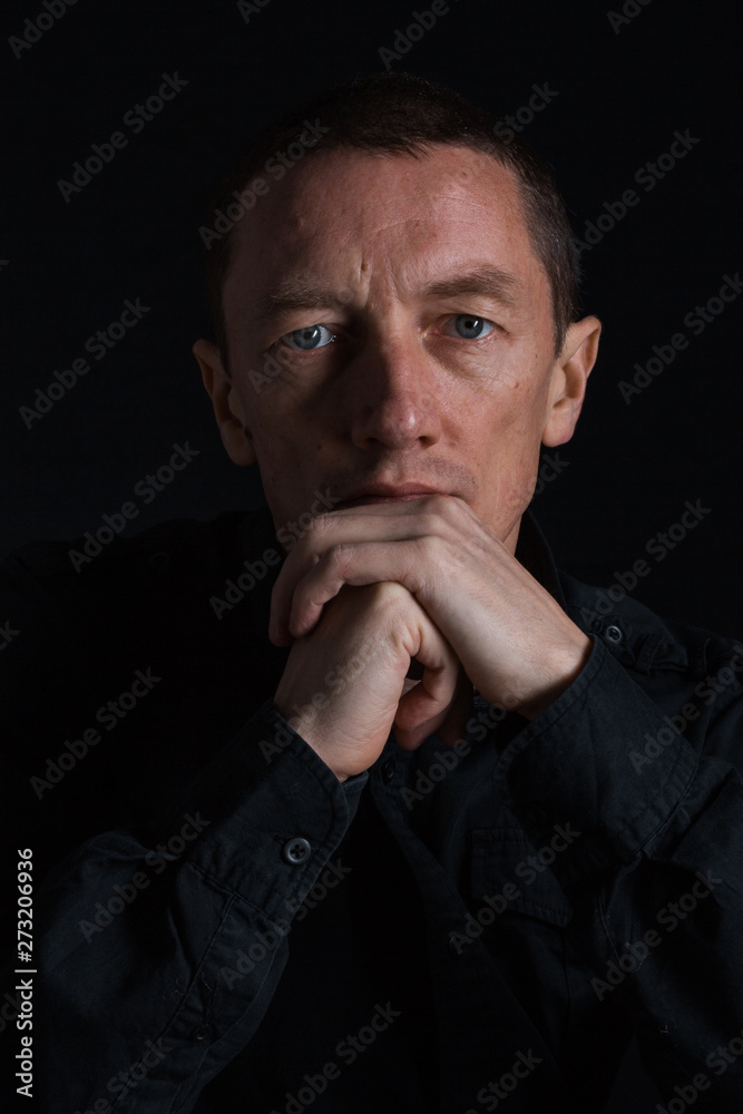 outdoor portrait of a very beautiful serious man, dark hair, posing in classic suit on black background outdoor portrait of a very beautiful serious man, dark hair, posing in classic suit on black background