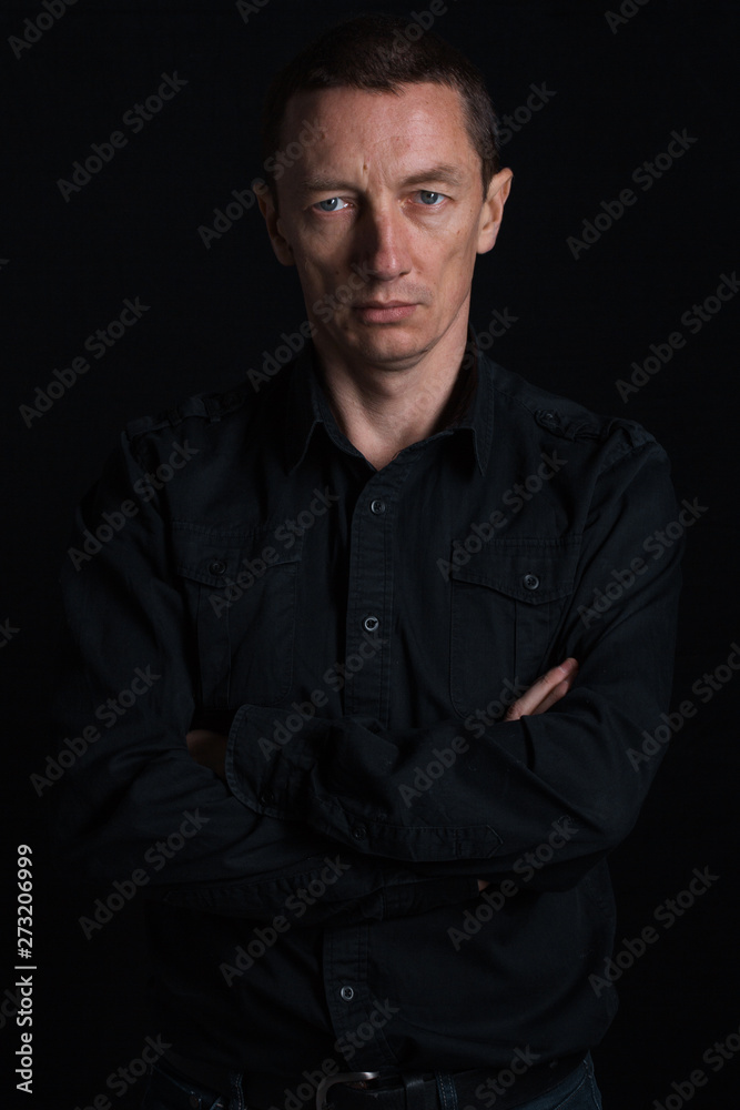 outdoor portrait of a very beautiful serious man, dark hair, posing in classic suit on black background outdoor portrait of a very beautiful serious man, dark hair, posing in classic suit on black background