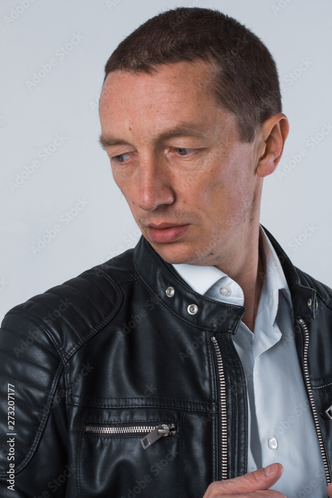 Obraz premium portrait of a very beautiful old serious man, dark hair, posing in classic suit on white background