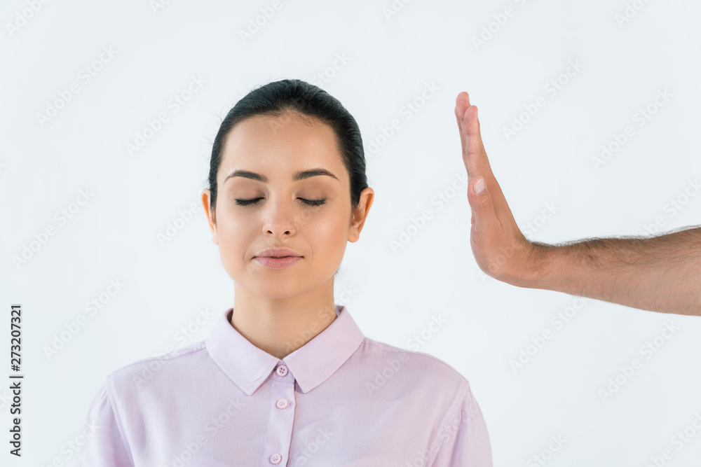 cropped view of man healing attractive girl with closed eyes isolated on white cropped view of man healing attractive girl with closed eyes isolated on white