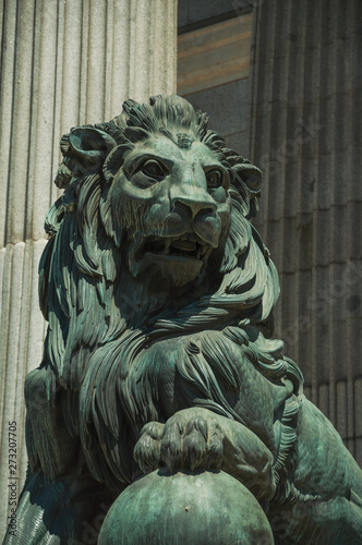 Sculpture lion cast in bronze on building facade in Madrid