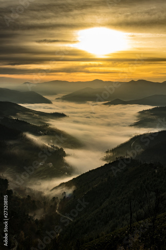 sunset in the mountains with fog