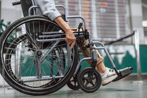 Mature lady on disabled carriage moving at airport