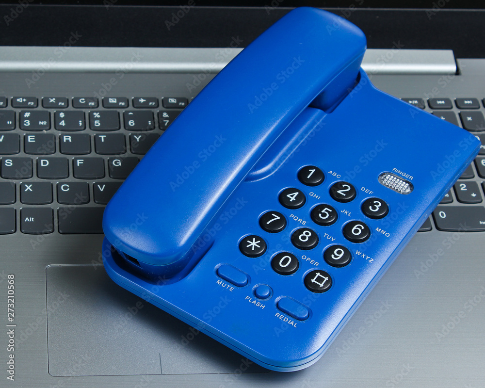 Office phone on the laptop keyboard. Call center Office phone on the laptop keyboard. Call center