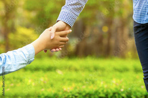 Woman and man are holding hands together, Happy love in the garden. romantic atmosphere in the parks. concept couple lover valentine day. shake hands, love in the evening sun.