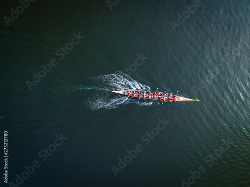 Aerial view of a single rowing boat and oarsmen in Dubai Creek, UAE. photo