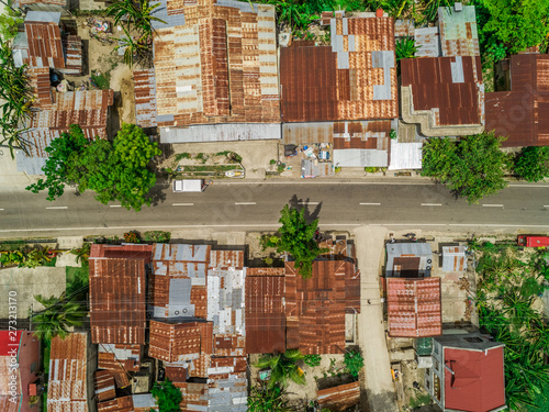 Aerial view of metal rooftops and road in Argao, Philippines.