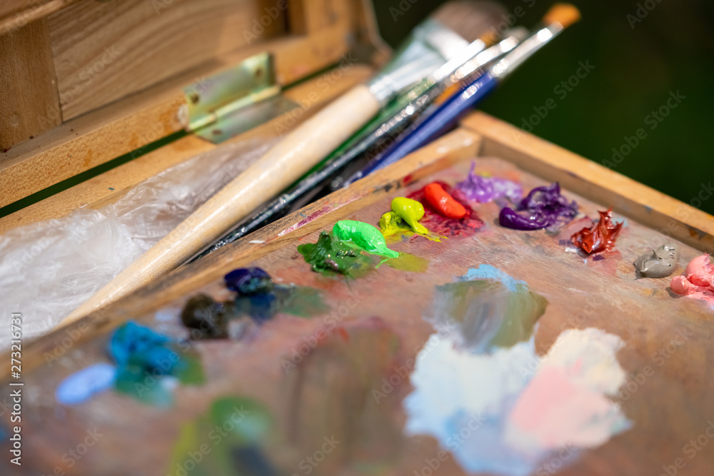 Fototapeta premium Artist's tablet with paints and brushes