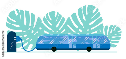 Electric bus in the city on recharging the battery at the bus stop. Eco-friendly bus powered by electricity. Public transport is safe and eco. Against the background of the green leaves of Monstera.