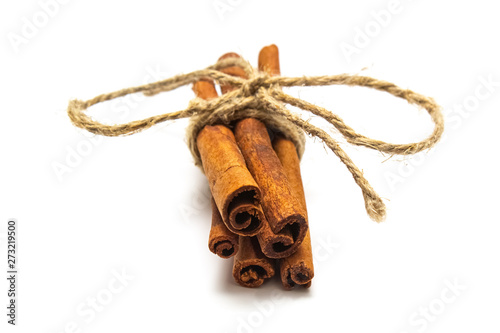 sticks of dry cinnamon tied with a twine (rope) on a white background, isolate for designers