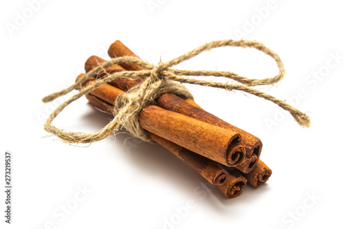 sticks of dry cinnamon tied with a twine (rope) on a white background, isolate for designers