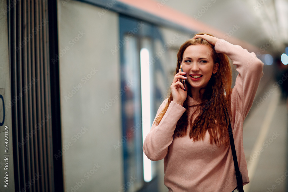 Fototapeta premium Positive redhead young female portrait. Moscow metro.