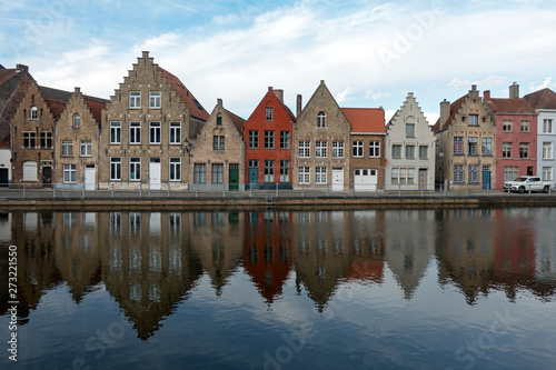 Beautiful old houses along the canal in Bruges, Belgium reflected in the water