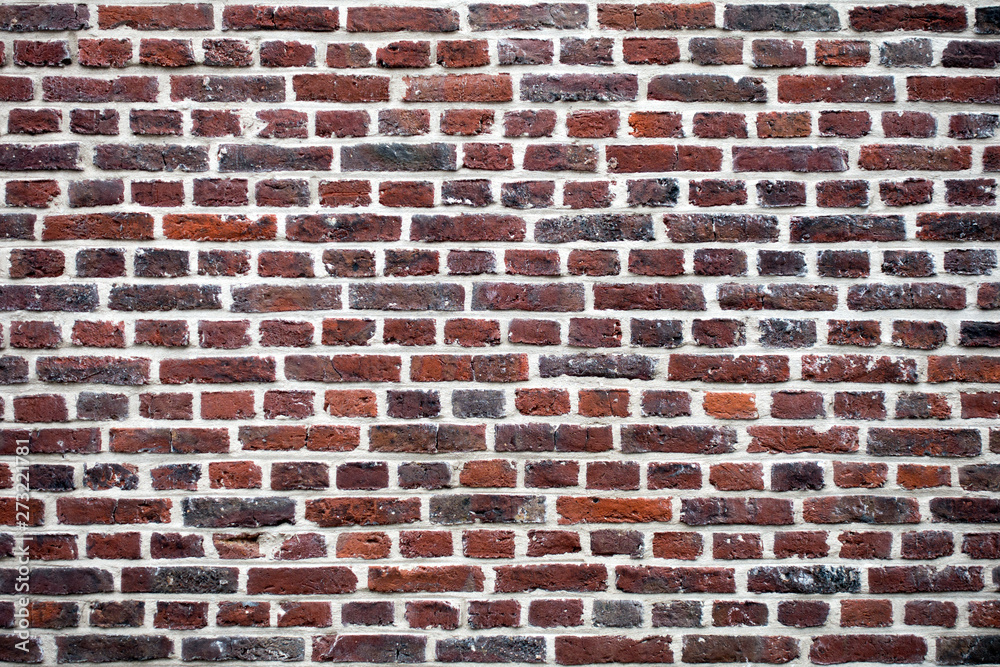 Multicolor wall of red and brown bricks. Texture background Multicolor wall of red and brown bricks. Texture background