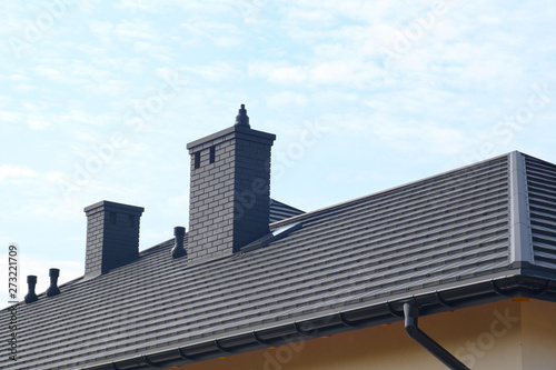 A fragment of the roof made of metal roof tiles. A newly built residential house.