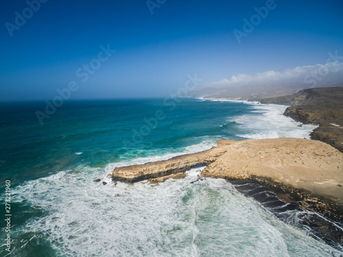 Aerial view of waves crashing of the rocks of punta Guadalupe in Fuerteventura, Canary Island. photo