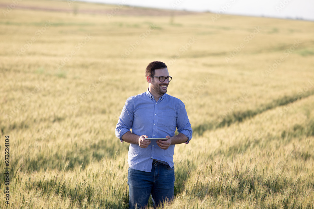 Farmer with tablet in barley field Farmer with tablet in barley field