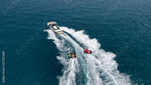 Aerial photo of extreme powerboat donut watersports crusing in high speed in tropical turquoise bay