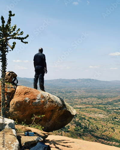 A hiker against the panoramic arid mountain landscapes of rural kenya  Kilome Plains  Eastern Kenya