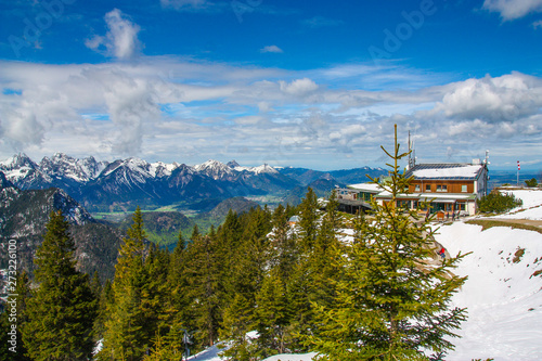 Panorama view from Tegelberg to the Alps landscape. Sunny spring day, snow covered mountains, blue sky, sunshine (Schwangau, Ostallgäu, Allgäu, Allgau, Bavaria, Germany) photo