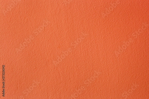 Abstract orange painted wall. Bright plaster colored texture