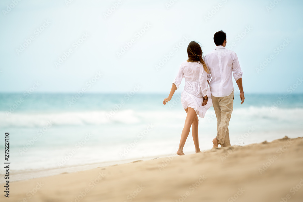 romantic couple walking on tropical beach romantic couple walking on tropical beach