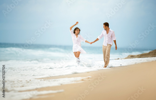 Young couple having fun on beach © luckybusiness