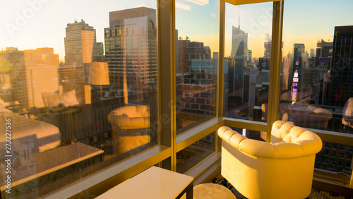 CLOSE UP: Morning sunshine illuminates the hotel room with a view of the city