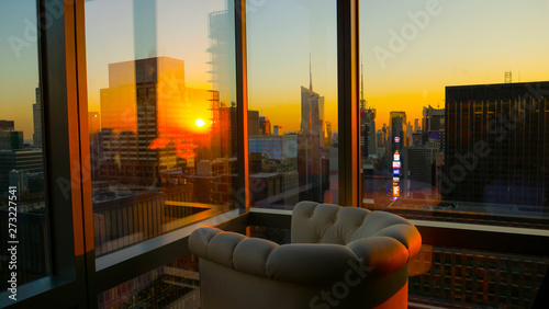 CLOSE UP: Morning sunbeams reflect off hotel room window above Times Square.