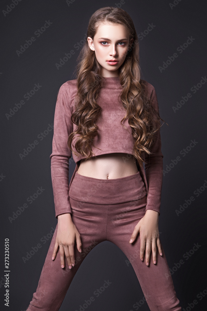 Teen girl posing in studio on black background Teen girl posing in studio on black background