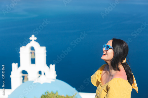 Fototapeta Naklejka Na Ścianę i Meble -  Woman Standing By Church  Against Sky, Thira, Santorini,  Greece