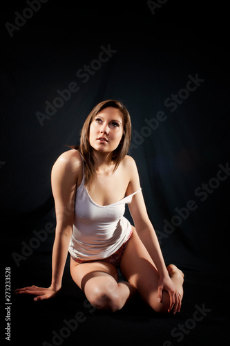 Beautiful Brunette Girl sitting On Black - In her Underwear