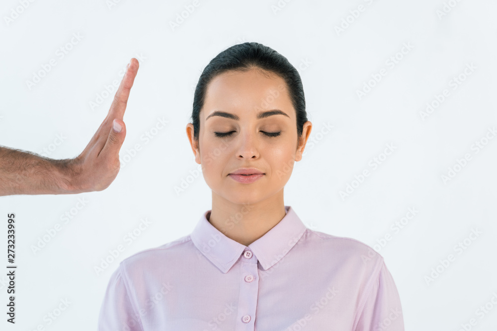 cropped view of healer holding hand near attractive woman with closed eyes isolated on white